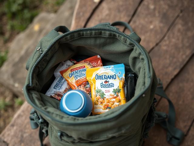 A backpack and map with healthy portable snacks ready for an adventure